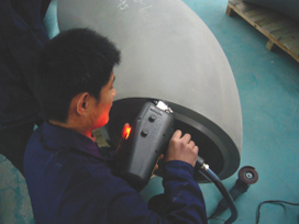 Mobile metal analyzer testing a formed head.