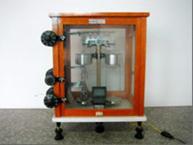 Analytical balance in its glass case.