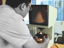 Technician at the Charpy V-notch projector.