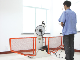 Impact testing machine behind its safety guards.