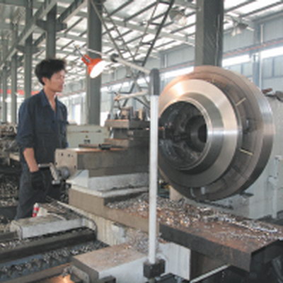 Heavy lathe turning a large flange.